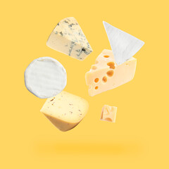 Different kinds of cheese falling on golden background