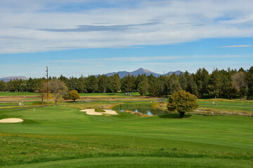 Fototapeta na wymiar Beautiful and challenging Central Oregon golf course near Redmond and Bend. Rolling terrain with view of Mt. Bachelor and featuring picturesque water hazards. Approximately 180 miles from Portland.