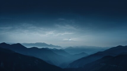 Fototapeta premium a view of a mountain range at night with the moon in the sky and a few clouds in the sky.