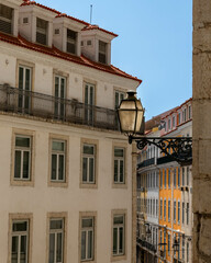 Lisbon, Portugal - 21.08.2023: Lantern on the wall of a house on a colorful Lisbon street