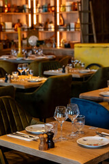 Wooden square table in a cafe for two with plates and empty glasses