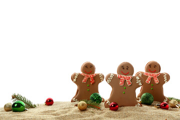 Tasty gingerbread cookies with fir twigs and Christmas balls on sand against white background