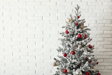 Beautiful Christmas tree on white brick background