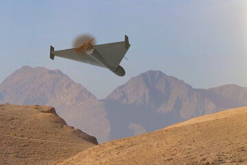 A military kamikaze drone flies over mountains in the desert against a backdrop of sky and clouds, war in Israel