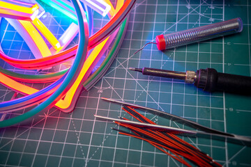 Multi-colored electric tape made of flexible LEDs.Soldering electrics for lighting in outdoor...