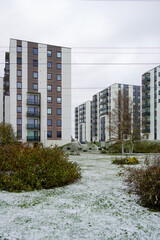 Apartments building in Lasnamae district. White snow on a grass. Tallinn, Estonia, Europe. October 2023