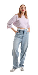 Young woman in trendy jeans on white background