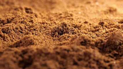 Textured ground coffee showcasing the natural beans of Arabica. A rich background for coffee enthusiasts