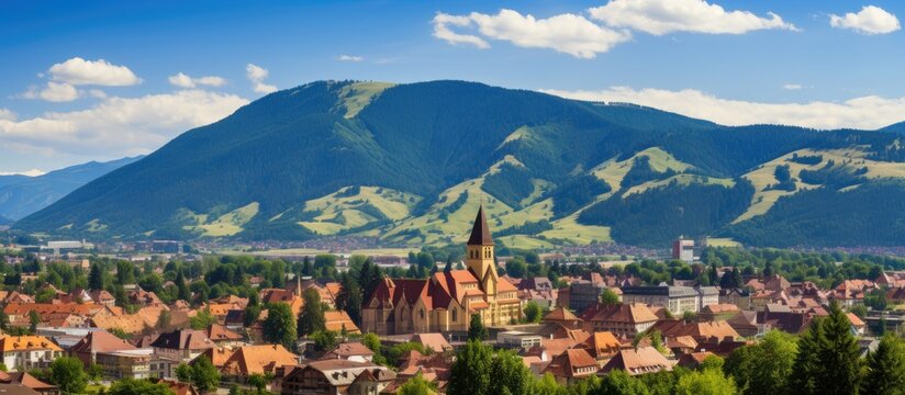 In the scenic city of Brasov, Romania, travelers are captivated by the breathtaking landscape, encompassing majestic mountains and beautiful old architecture, with its Gothic-style buildings painting