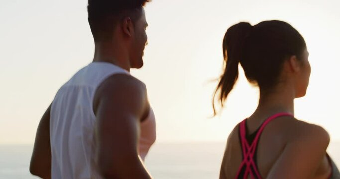Fitness, back view or couple on beach running for exercise, training or outdoor workout together. People, runners or healthy athletes in nature for sports endurance, wellness or challenge at sunset