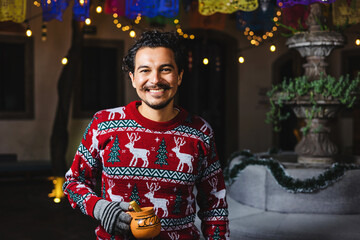 Latin man at traditional posada party for Christmas celebration in Mexico Latin America, holidays and Christmas eve - obrazy, fototapety, plakaty