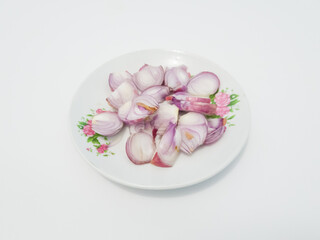 Sliced red onion on a white plate on a white background