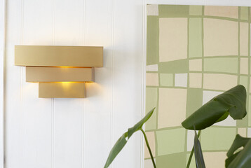 Vintage gold lacquered brass tiered wall sconce. Mid-Century Modern minimalist lighting. Interior...