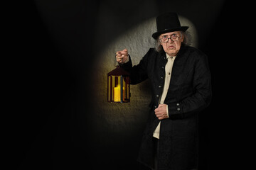 Scrooge with a lantern, in front of a one-spot background - obrazy, fototapety, plakaty