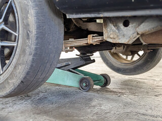 old Vehicle and the floor Jack Lift vehicle servicing and maintenance