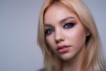 Naklejka premium Sensual lovely beauty young woman in studio. Portrait of beautiful girl. Pretty girl face on isolated background. Sensual look of attractive seductive charming lady.