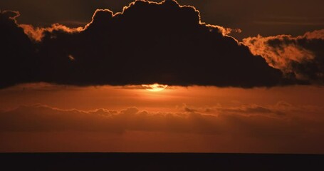 Sunset 4K dusk twilight evening timelapse dark clouds. Sea horizon with vibrant glow and nightfall colors. Majestic scenic view time lapse