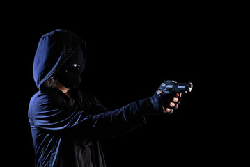 Masked person pointing gun