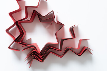 zig-zag red paper stripes with embossed pattern folded and arranged standing on one edge and...