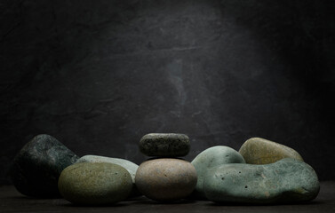 composition of stones on a dark background for the podium. minimalistic still life with natural stones for product presentation, background.