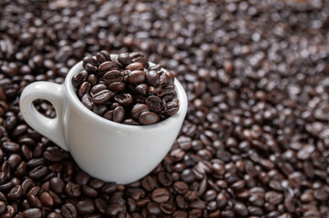 Coffee mug full of coffee beans