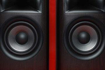 Modern wooden sound speakers on red background, closeup