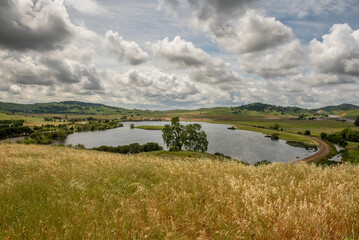 The Lagoon Valley Park in Vacaville, California, USA, viewed from a hill, on a beautiful partly cloudy spring day - 684021514