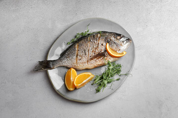 Seafood. Delicious baked fish served with orange and microgreens on light textured table, top view