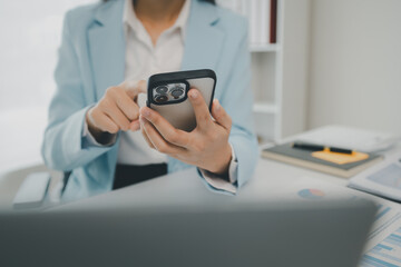 An entrepreneur is talking on the phone with a company customer, Businesswoman is sitting and working in the office, Recording various information on paper,