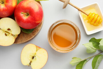 Sweet honey and fresh apples on white table, flat lay