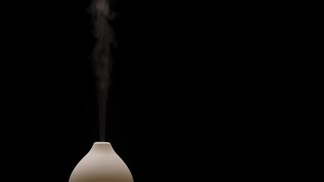 Diffuser diffusing steam on black background. Closeup