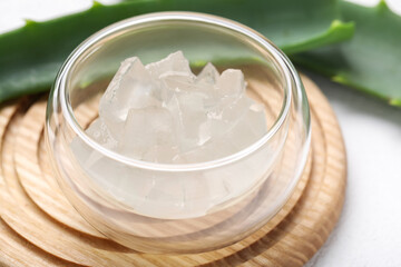 Fototapeta na wymiar Aloe vera gel in bowl on white background, closeup