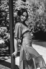Beauty and latino charm: beautiful brunette model with a fashion look in a sunny day in the park (in black and white)