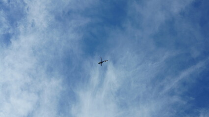 A helicopter flying over with the blue sky as background