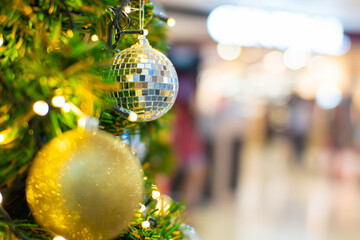 Christmass ball ornament on pine tree blurred bokeh background winter season