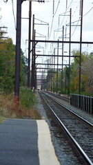 The railroad view with the parallel iron tracks and platform as background