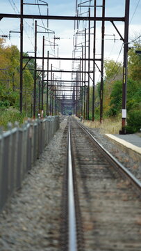The railroad view with the parallel iron tracks and platform as background