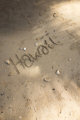 Hawaii handwritten in the sand surface