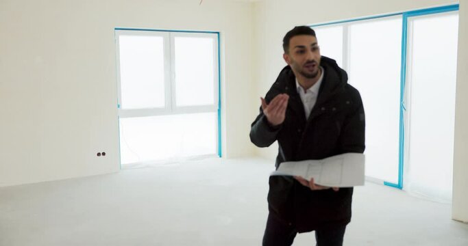 Male real estate manager showing new moern hous home to young successful happy family.