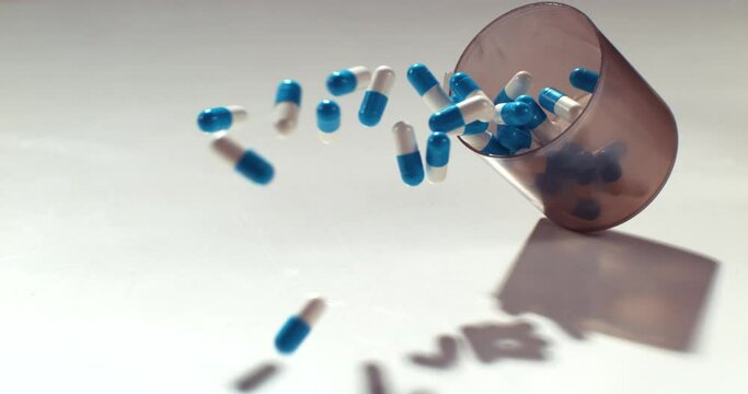 Bottle, falling and pharmaceutical drugs or pills on white background in studio for healthcare mockup. Medication, tablet and container of supplements or antibiotics for healing, health and wellness