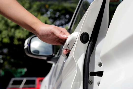 Male hand opening car door