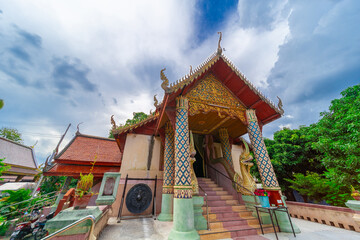 Beautiful Wat Buddhist temples in Chiangmai Chiang mai Thailand. Decorated in beautiful ornate colours of red and Gold and Blue. Lovely sunset