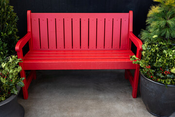 Festive seating, bright red bench in a rustic setting
