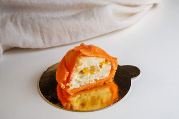 Cut Mango Japanese cookies Mochi in rice dough and cream cheese on a golden dessert tray. Traditional Japanese dessert close up, inside view