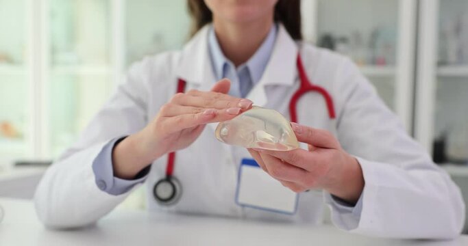 Doctor plastic surgeon shows breast implants
