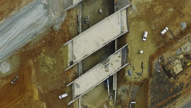 Rural, infrastructure and construction of bridge from drone and building in countryside with concrete on dirt. Industrial, development and aerial view of cement on the ground for tunnel and road