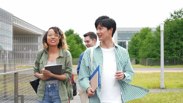 Multinational youth group walking in outdoor facility.