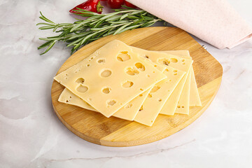 Sliced maasdam cheese with holes