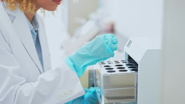 Female scientist using experimental equipment. Research and Development.