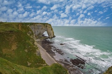 Etretat in Normandy with cliffs and needle.